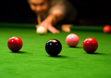 Man playing snooker on a snooker table